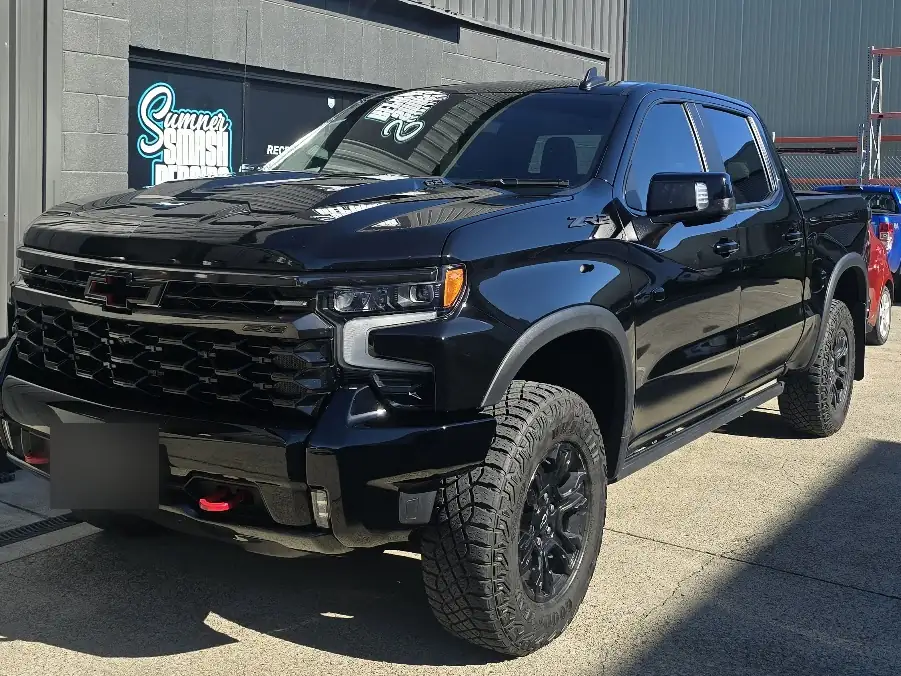 Black Chevrolet Silverado parked outside the Sumner Smash Repairs workshop